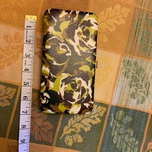 Hard cover wallet with clasp closure.